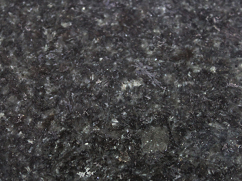 Charcoal granite sample — Charcoal grey with lighter mineral details.